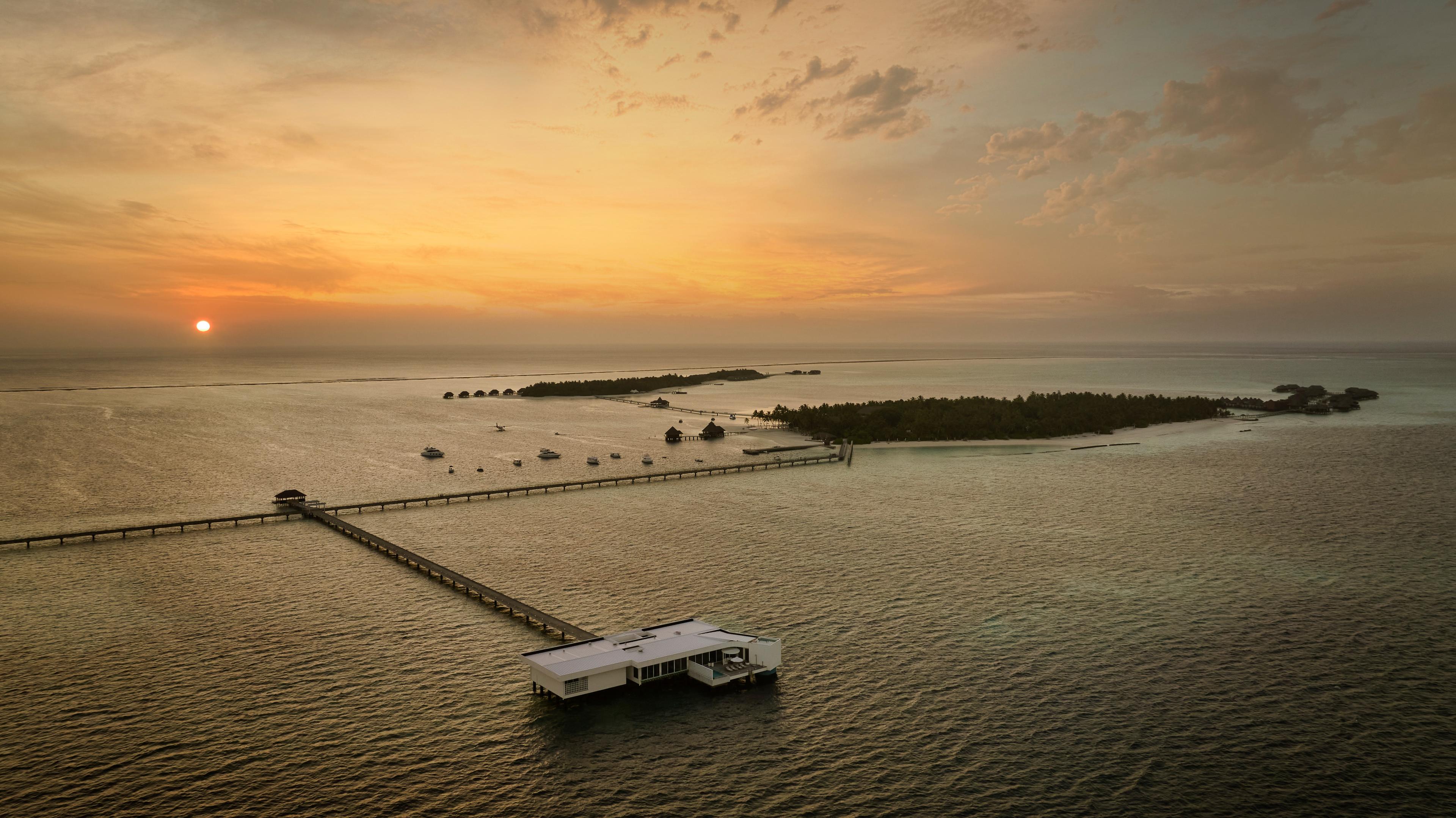 ConradMaldives_TheMuraka_Aerial Sunset_JohnAthimaritis_HighRes.jpg