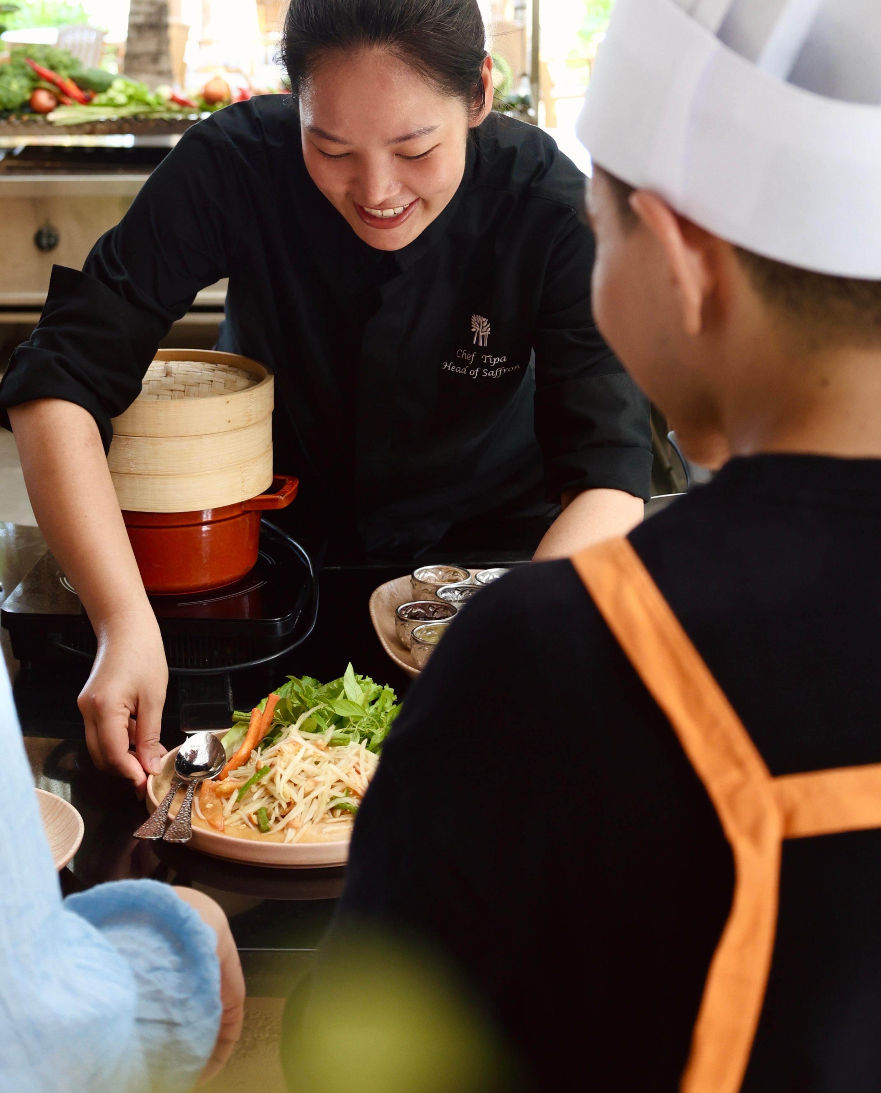 Chef Tipa at a cooking class with guests.jpeg