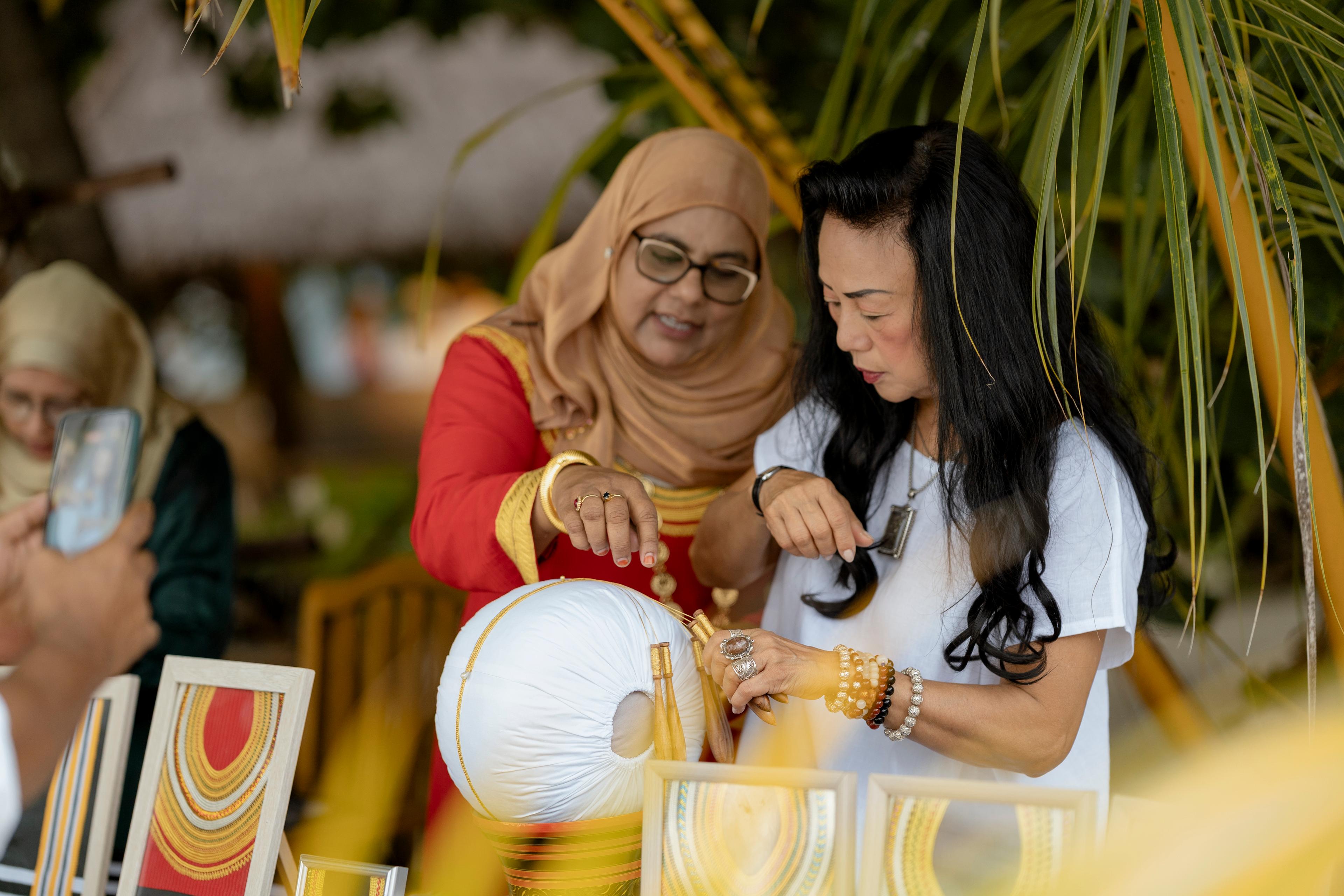 Banyan Tree Vabbinfaru - 30th Anniversary - A local woman showing Chairwoman how to embroider Kasabu Viyun.jpg