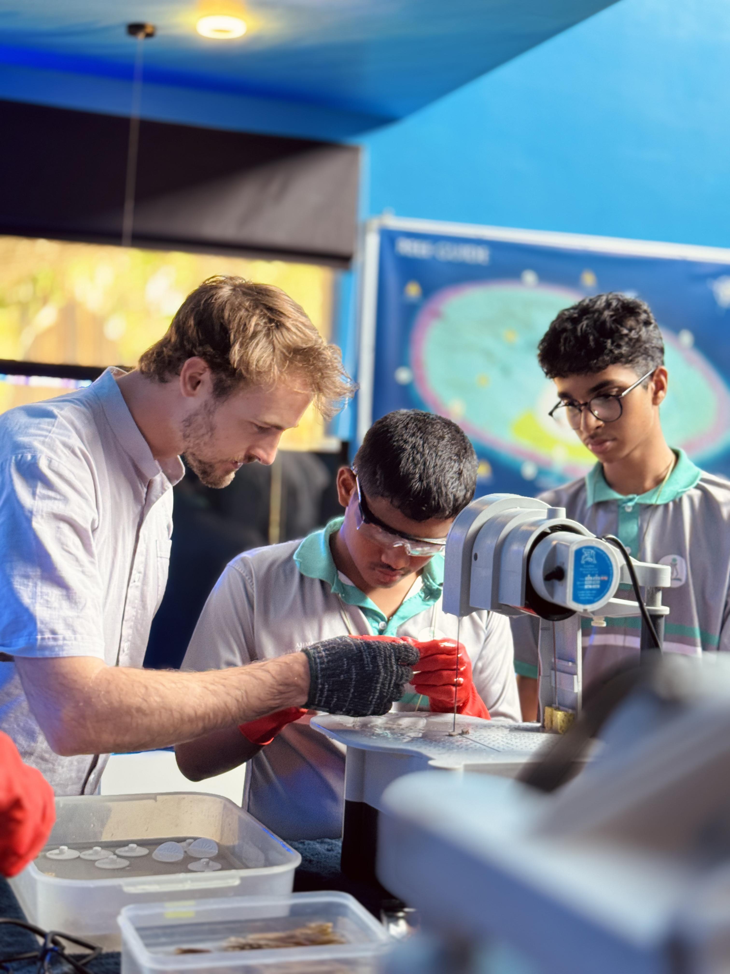 Alex Burden - Marine Lab and Sustainability Manager and the students.jpg