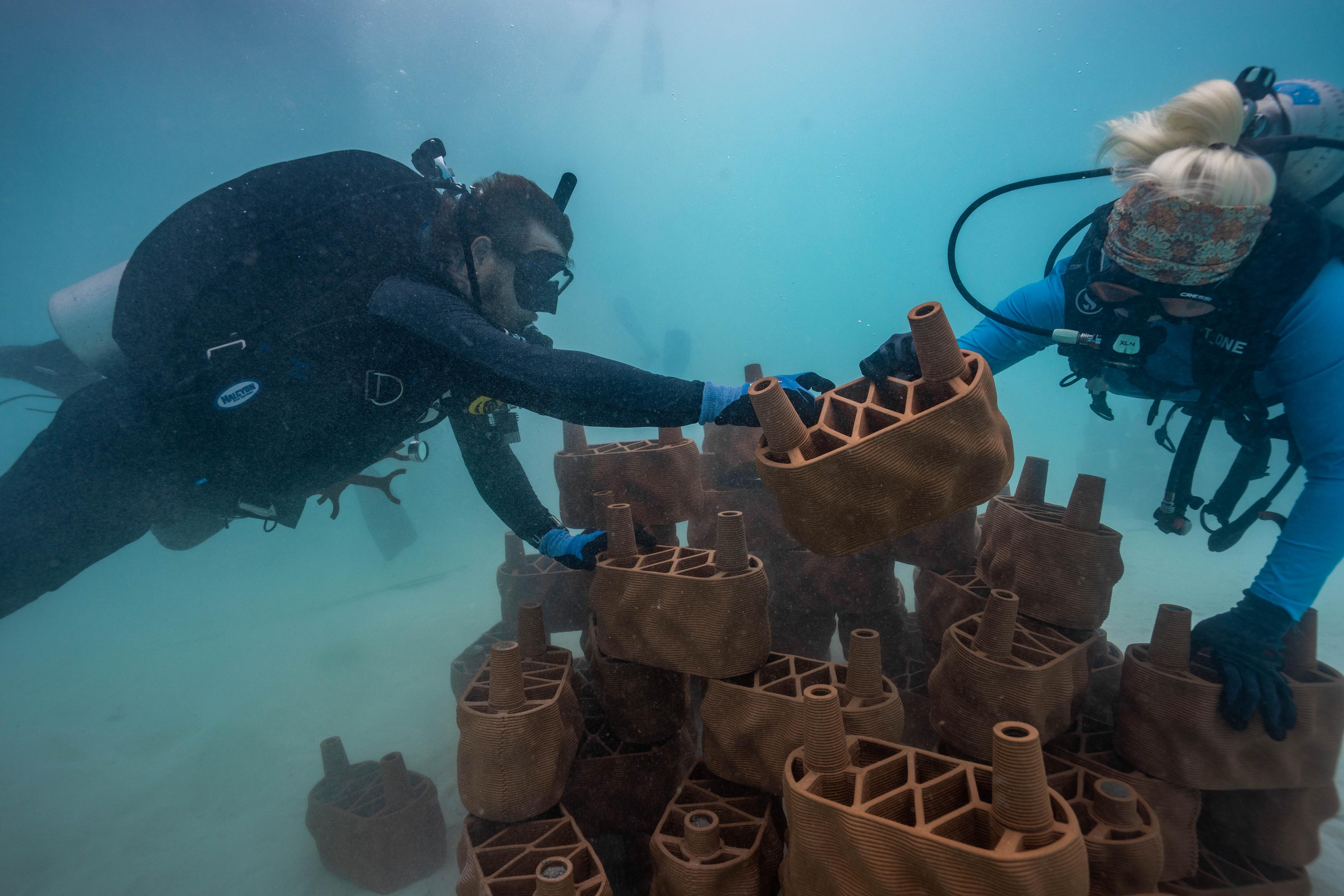 680537-One clay brick at a time, marine conservation takes shape beneath the surface as divers carefully assemble the artificial reef-4e.jpg