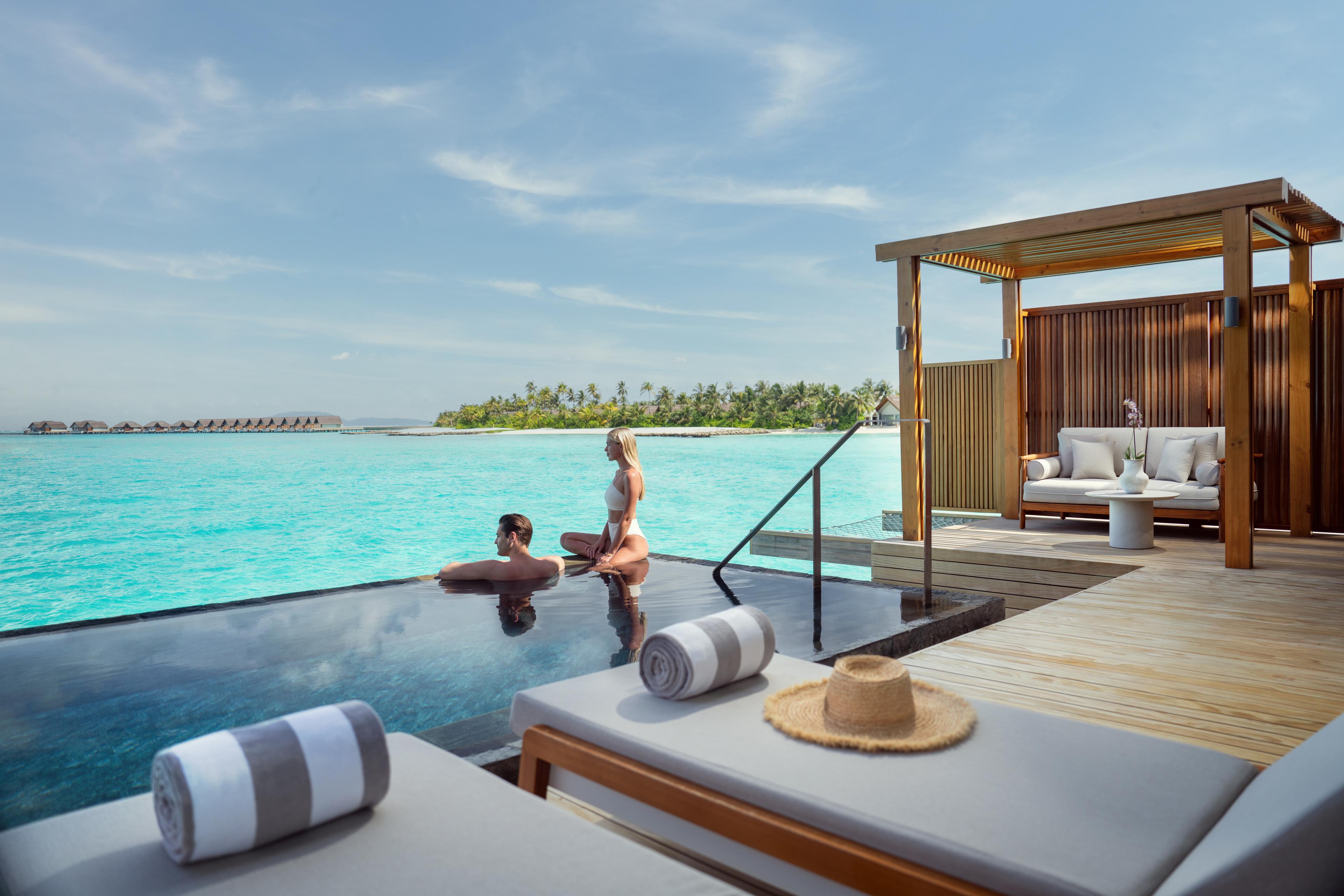 JW Marriott Maldives Kaafu Atoll Island Resort_Couple_Overwater Pool Villa.jpg